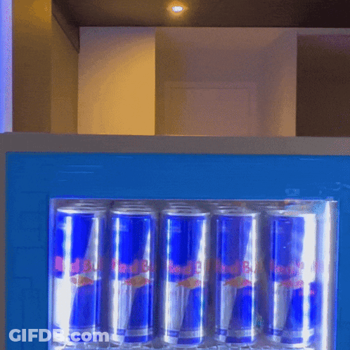 Cans Of Red Bull Are Lined Up In A Fridge GIF