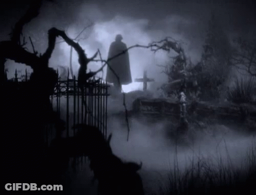 Caped Man Silhouette In Cemetery At Night GIF