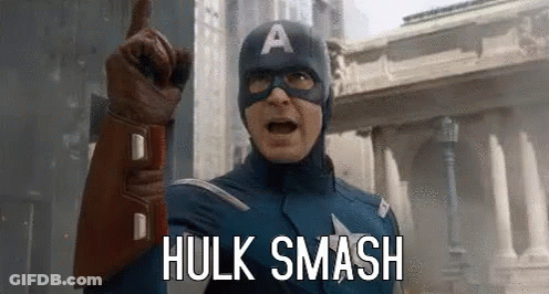 Captain America Is Pointing Up And Saying `` Hulk Smash '' While Wearing A Mask And Gloves . GIF