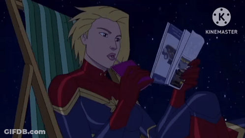 Captain Marvel Sitting In Chair Reading Book GIF