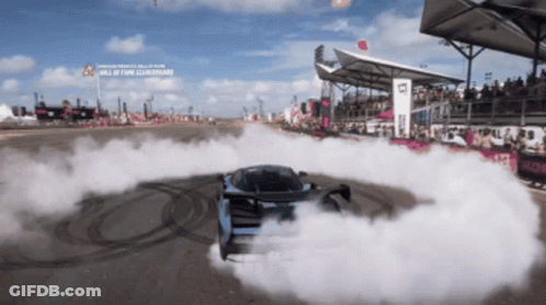 Car Drifting On Track With Hall Of Fame Sign GIF