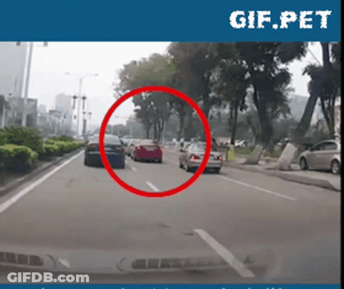 Car Driving Down City Street GIF