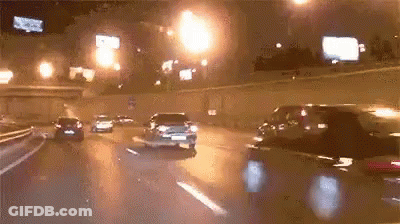 Car Driving Down Highway At Night With Lights GIF