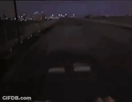 Car Driving Down Highway Past Anywhere Sign GIF