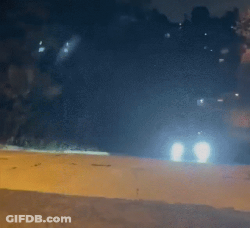 Car Driving Down Road At Night GIF
