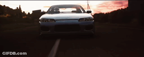 Car Driving Down Road At Sunset GIF