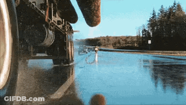 Car Driving Down Road Next To River GIF