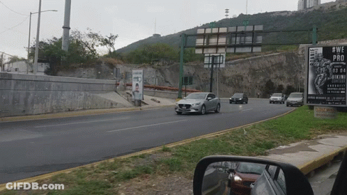 Car Driving Down Road Next To Sign Saying #Wepro GIF
