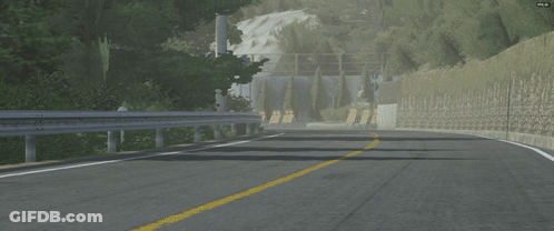 Car Driving Down Road Next To Stone Wall With Aomori Sign GIF