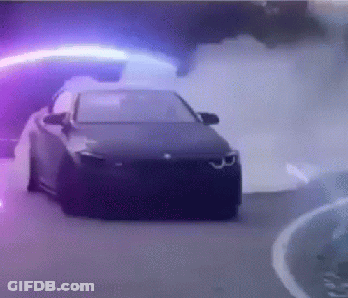 Car Driving Down Road With Purple Light GIF