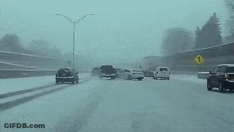 Car Driving Down Snowy Highway East Bound GIF
