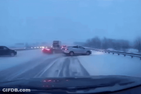 Car Driving Down Snowy Highway GIF