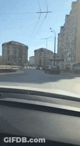Car Driving Down Street With Ambulance Sign GIF