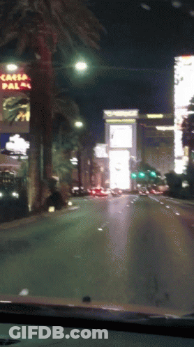 Car Driving Down Street With Casa Palma Sign GIF
