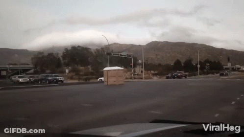 Car Driving Down Street With Mountains Viralhog GIF