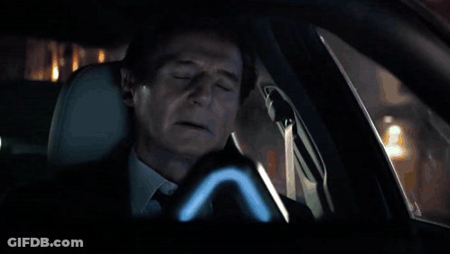 Car Driving Down Wet Street At Night With No Parking Sign GIF