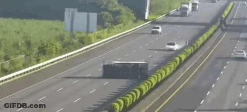 Car Driving Next To Overturned Semi Truck GIF