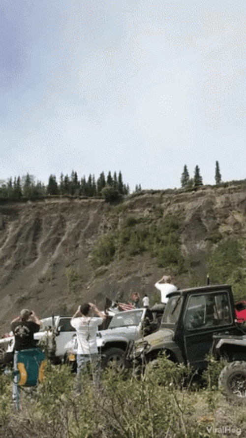 Car Driving Off Cliff With People Watching GIF