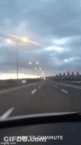Car Driving On Highway Under Cloudy Sky GIF