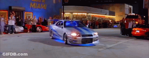 Car Driving Past Miami Building GIF
