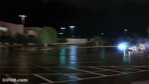 Car Driving Through Parking Lot Near Store GIF