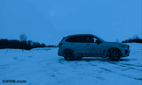 Car Driving Through Snowy Field With Trees GIF