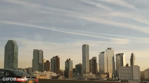 Car Parked In Front Of City Skyline GIF