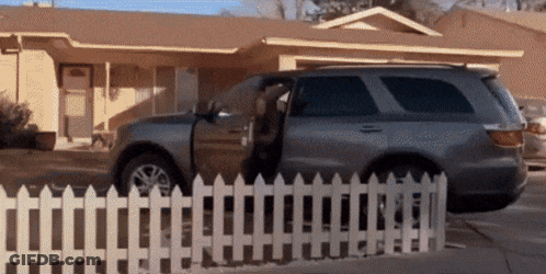 Car Parked In Front Of House With Door Open GIF
