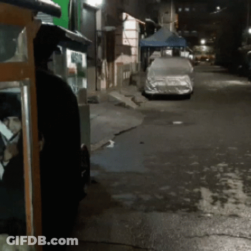 Car With Cover Parked On Road At Night GIF