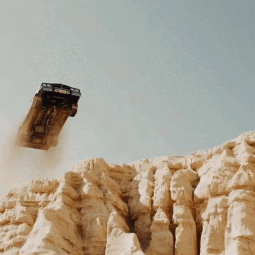 Car With Dusty Tires Driving Off Cliff GIF