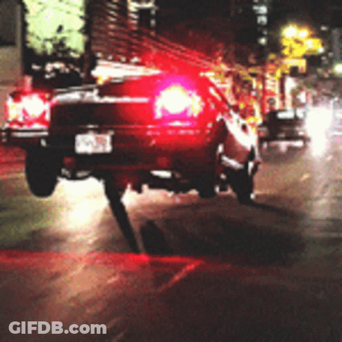 Car With NC License Plate Driving Down Street GIF