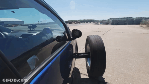 Car With Tire Attached Parked In Lot GIF