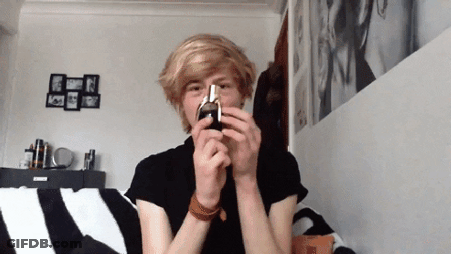 Carl Bradburry Shows Bottle Black Liquid GIF