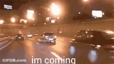 Cars Driving Down Highway At Night GIF