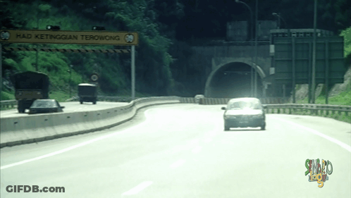 Cars Driving Down Highway With Sign Saying Had Ketinggian Terowong GIF
