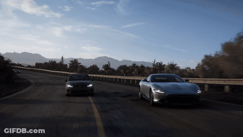 Cars Driving Down Road With Mountains GIF