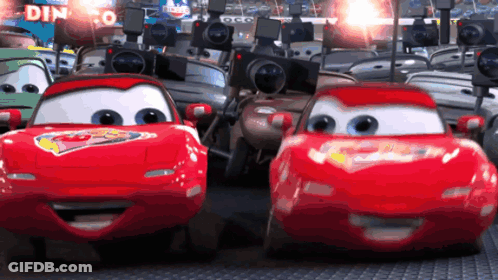 Cars Driving Past Dinoco Sign GIF