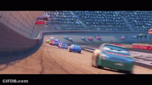 Cars Racing On A Track With A Sign That Says Motor Speedway On It GIF
