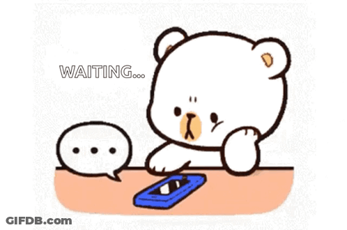 Cartoon Bear Sitting At Table With Cell Phone GIF