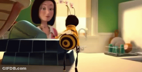 Cartoon Bee Standing On Counter Next To Woman GIF