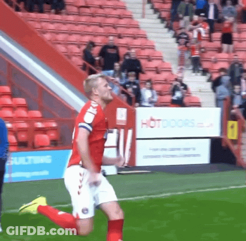 Cartoon Cat In Red Shirt Jumping On Soccer Field GIF