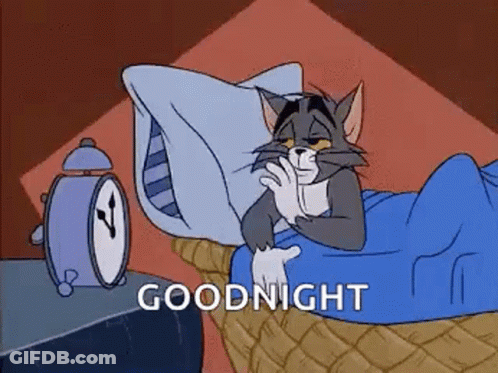 Cartoon Cat Laying In Bed With Alarm Clock GIF