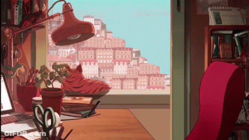 Cartoon Cat Sitting On Desk With Lamp GIF