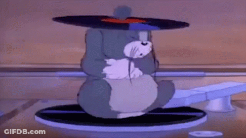 Cartoon Cat Sitting On Record Player With Record On Head GIF