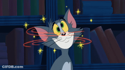 Cartoon Cat Smiling In Front Of Bookshelf GIF