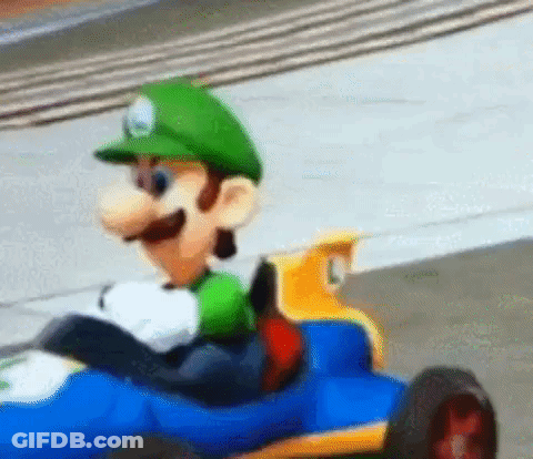 Cartoon Character Driving Toy Car On Race Track GIF
