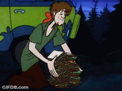 Cartoon Character Holding Sandwiches In Front Of Scooby Doo Vehicle GIF