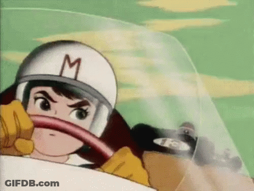 Cartoon Character In Helmet With M Driving Race Car GIF