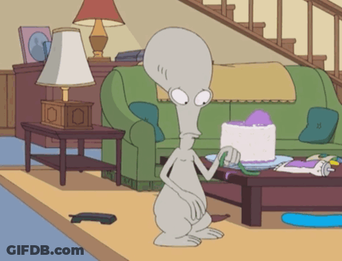 Cartoon Character In Living Room With Cake GIF