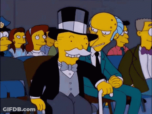 Cartoon Character In Top Hat And Bow Tie Sitting In Crowd GIF